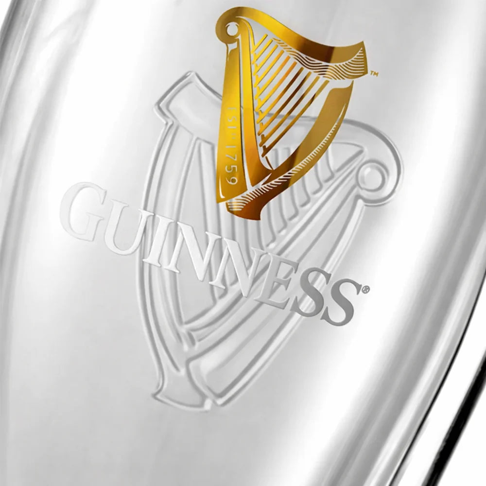 Close-up of a Guinness logo on a glass container