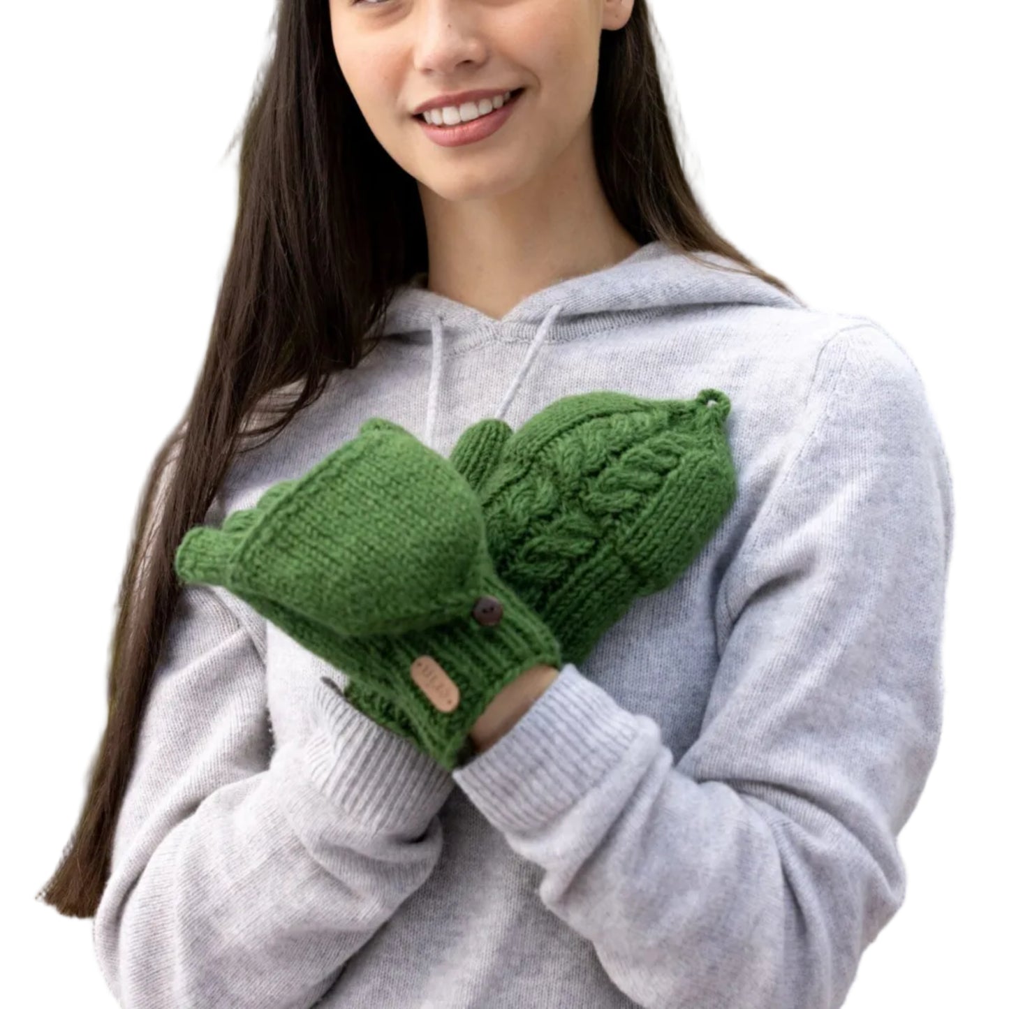 Woman wearing pair of green knit mittens. Top of one mitten is removed to reveal fingerless gloves underneath.