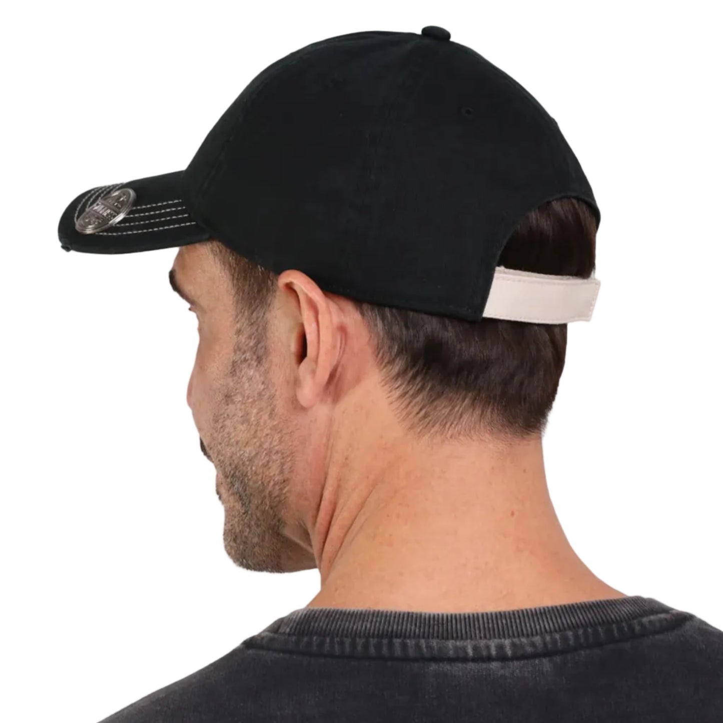 The back of a black baseball cap with a cream-colored velcro fastener.