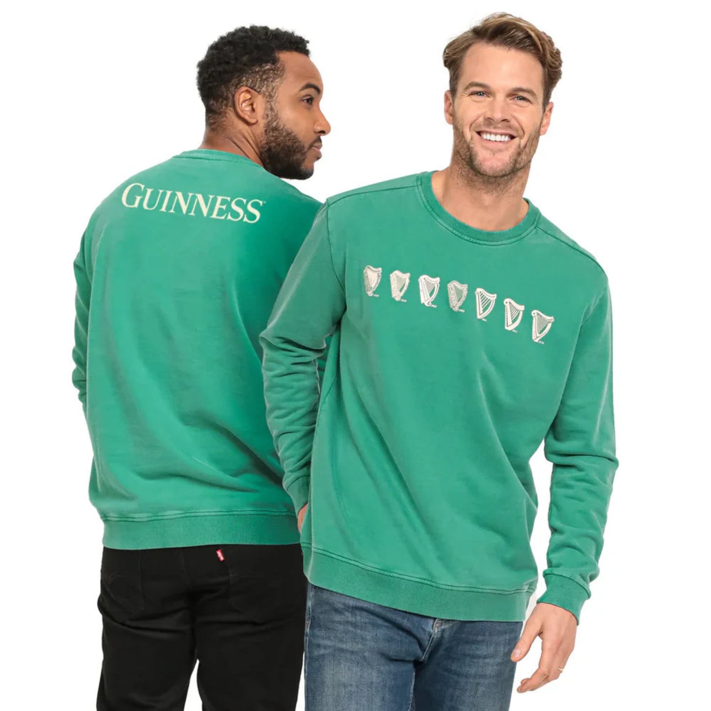 Two men wearing green guinness evolution sweatshirts. One man shows the harp designs on the front. One man turns to show the word "Guinness" written on the back.