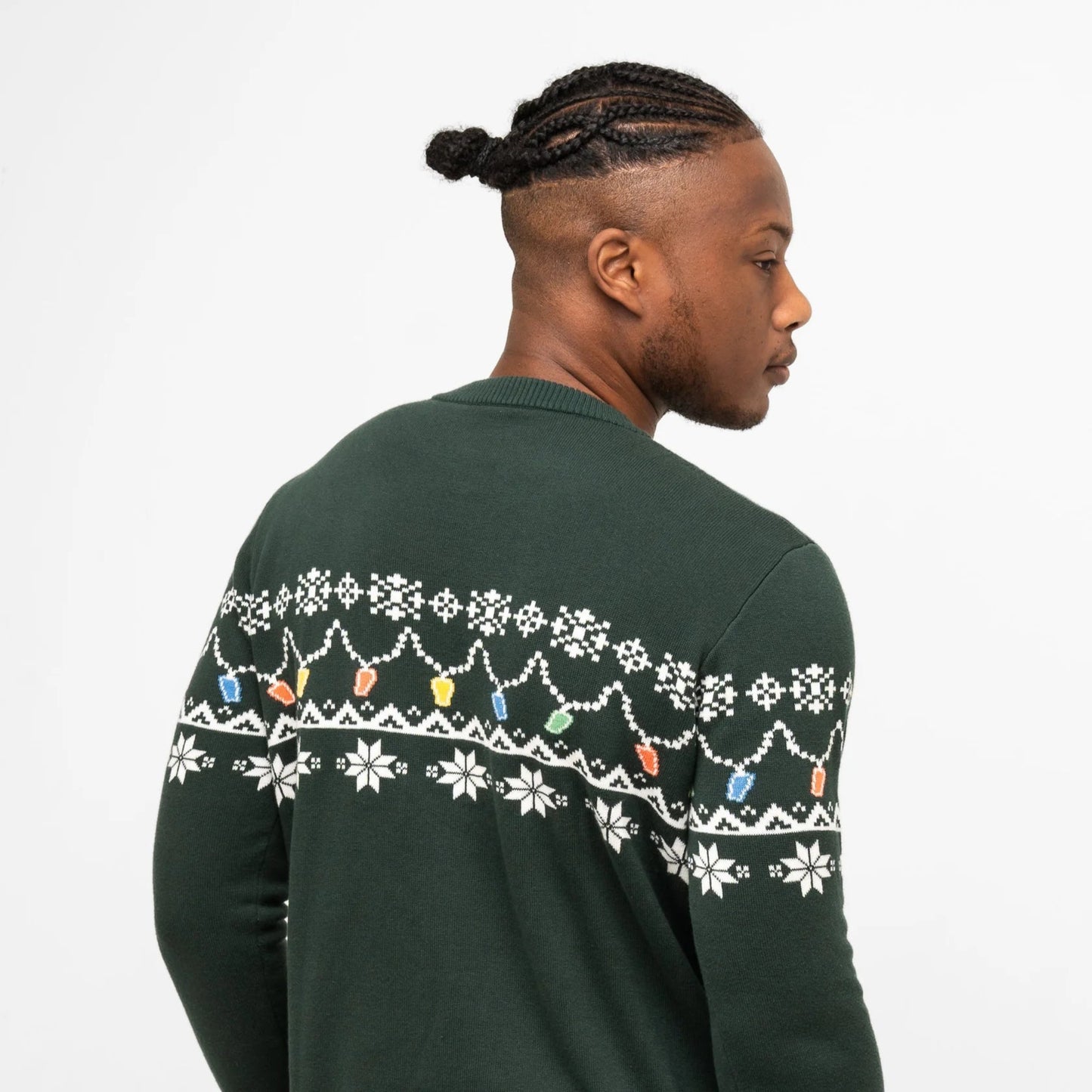Man showing the back of his green sweater with a pint-shaped christmas light pattern.