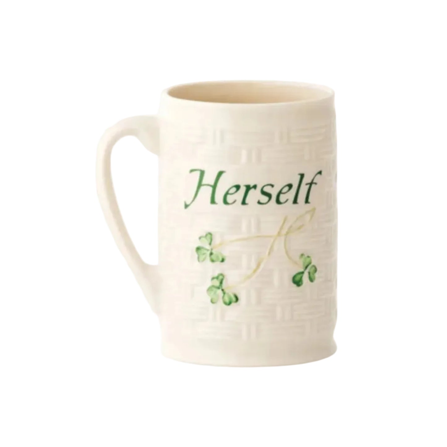 A white ceramic mug with green clover designs and the word 'Herself' printed on it.