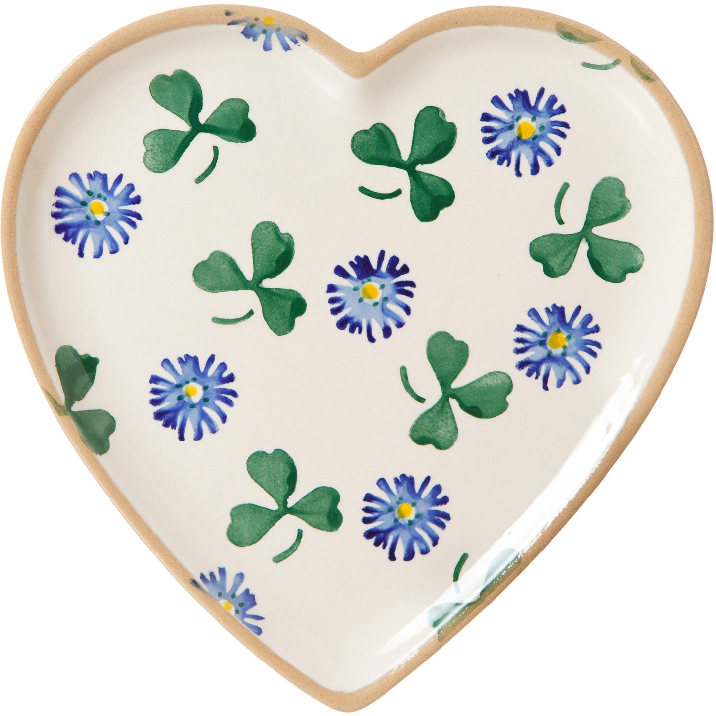 A heart-shaped plate with a floral design, featuring green clover leaves and blue flowers on a white background.