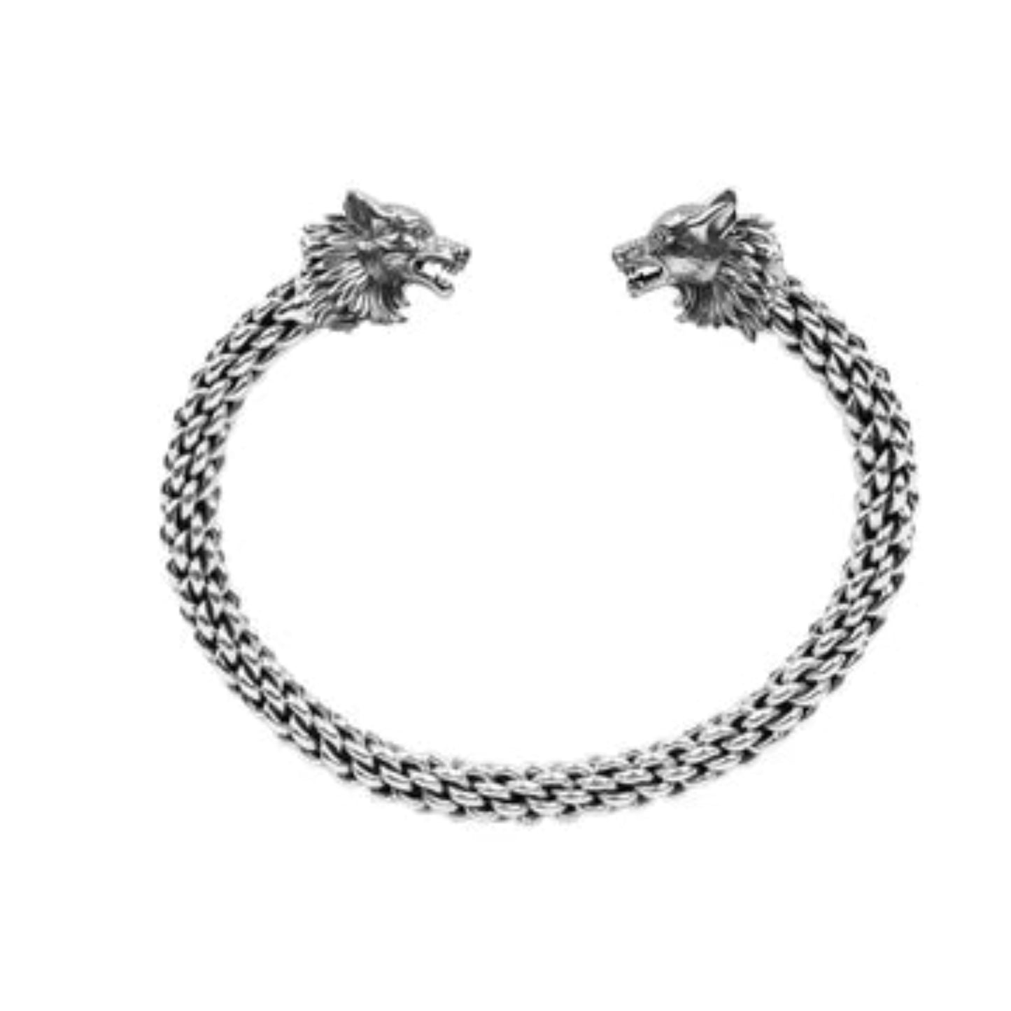 A flexible torc bracelet with a double headed wolf design, made from oxidized sterling silver or oxidized sterling silver and bronze.