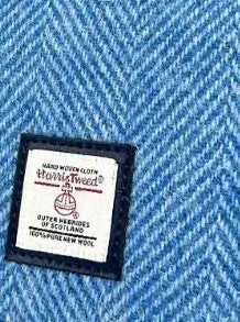 Close-up of a Harkila label on a blue fabric background