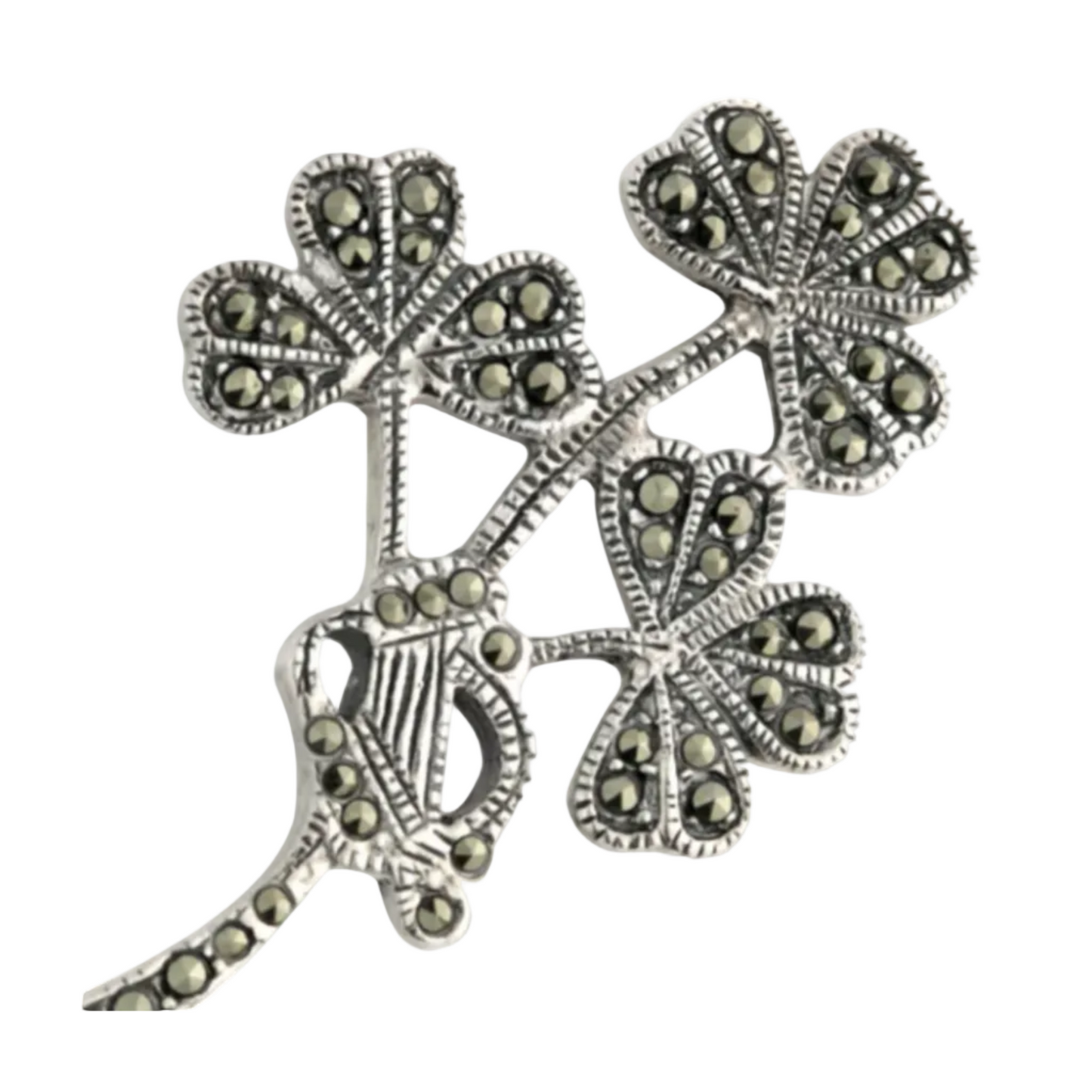 A silver brooch in the shape of a shamrock, adorned with small marcasite stones.
