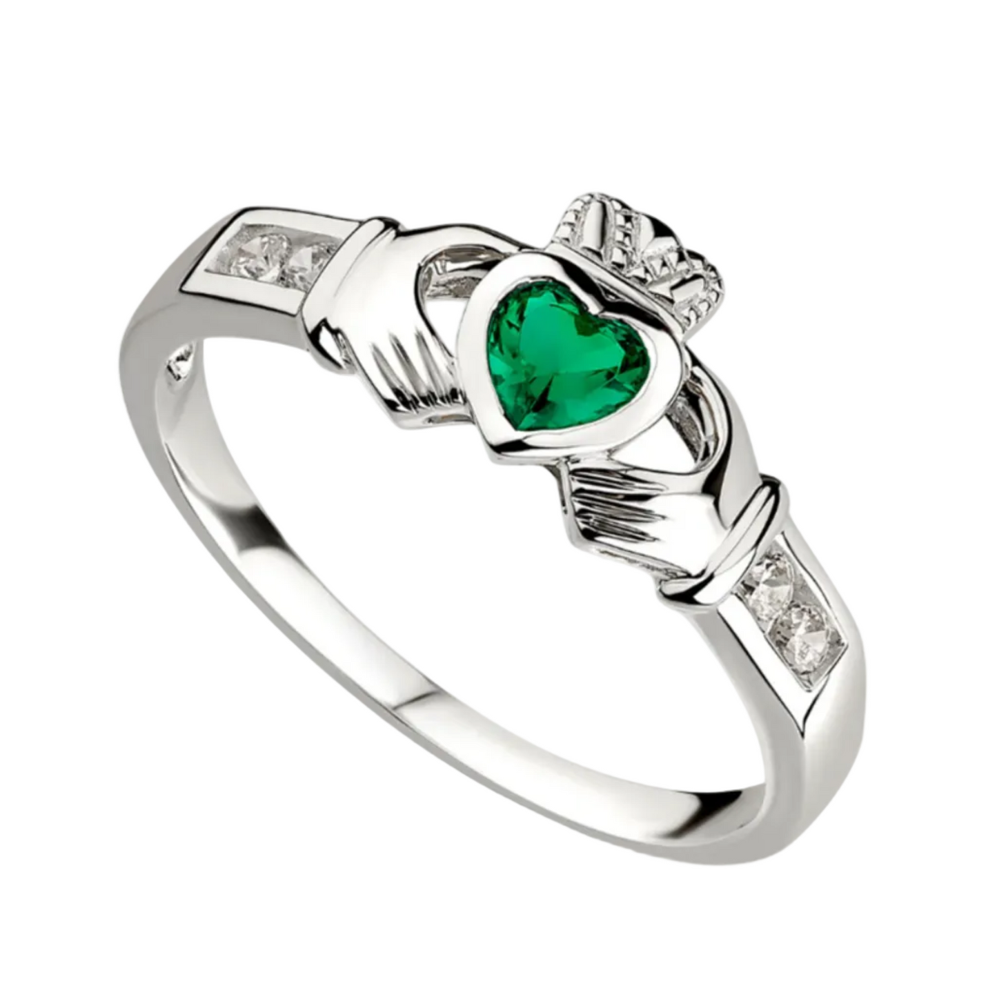 A sterling silver claddagh ring with two hands holding a crowned heart. The central heart is made of green emerald. Each hand's sleeve features two clear white stones.