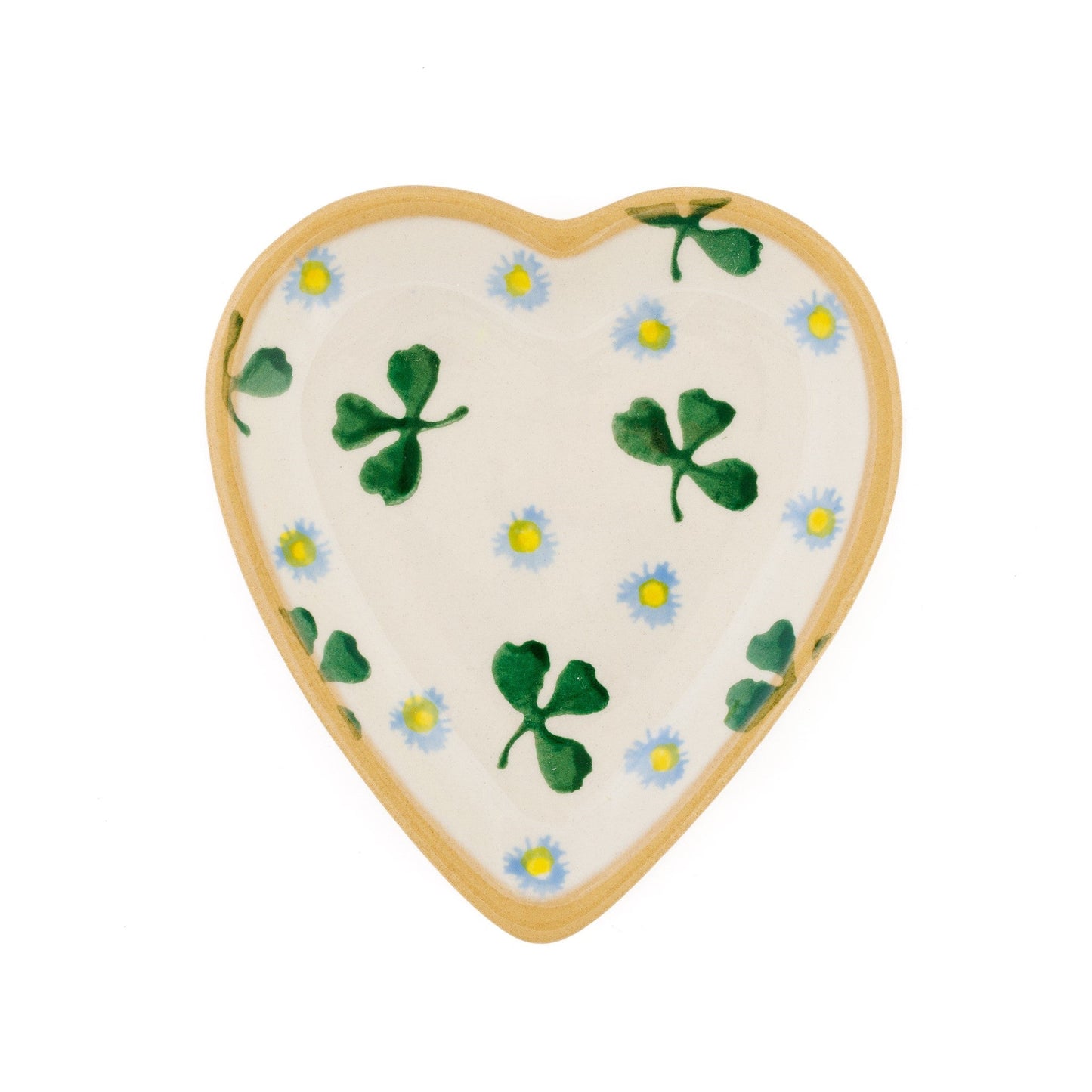 A heart-shaped, ceramic plate with a white background, featuring a green clover pattern and pale blue blossoms.