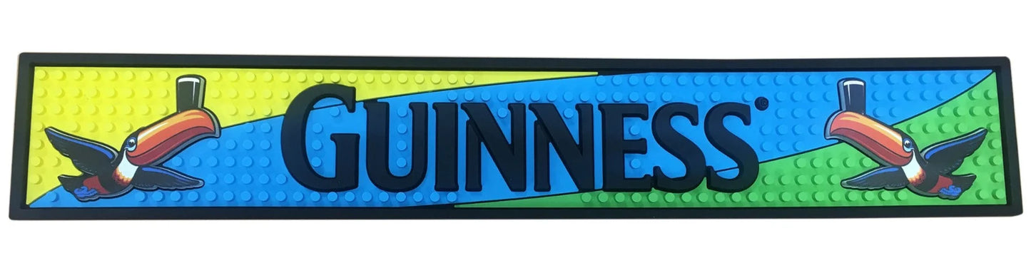 Guinness bar mat with toucan designs on a blue and green background