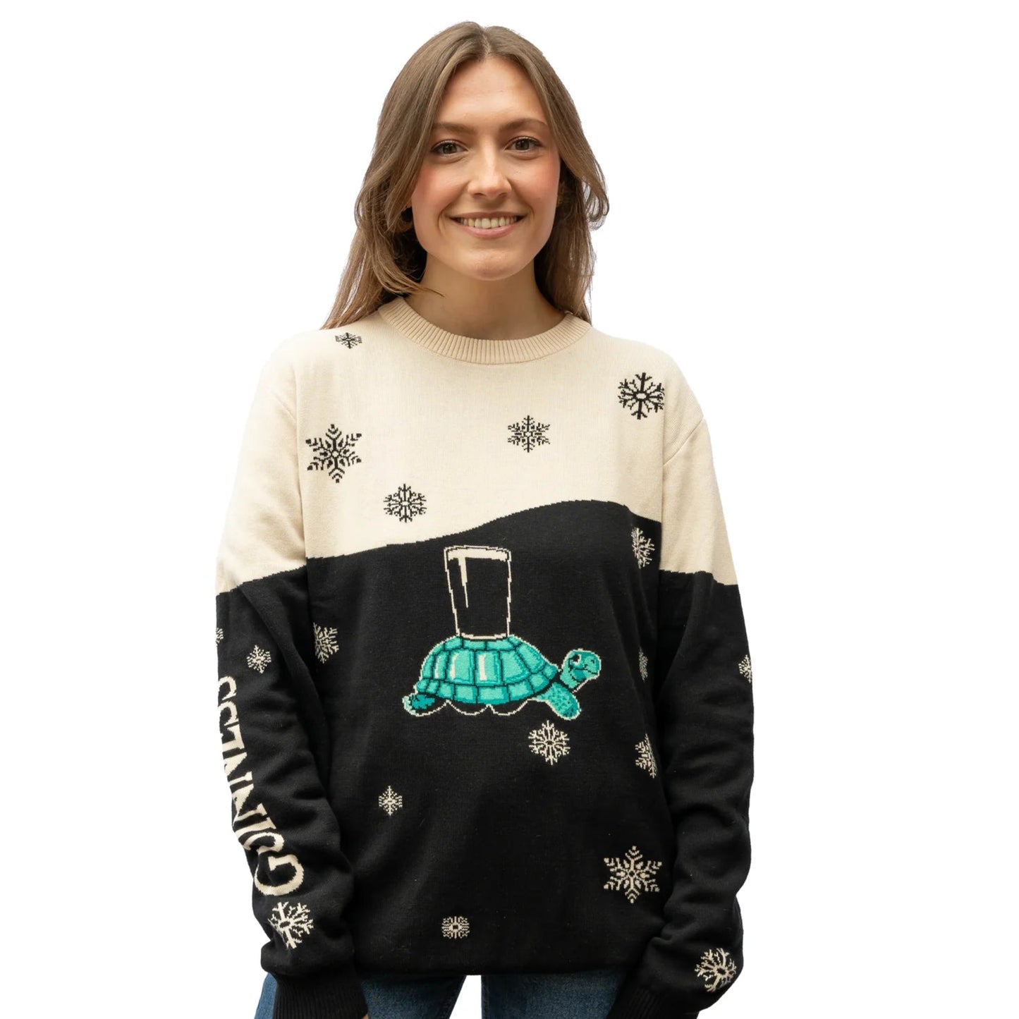 A person wearing a black and cream sweater with a tortoise design and 'Guinness' text on it.