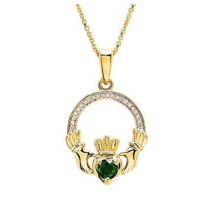 Gold claddagh necklace with diamonds and emeralds on a white background