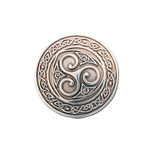 Decorative metal button with Celtic triskele design on a white background