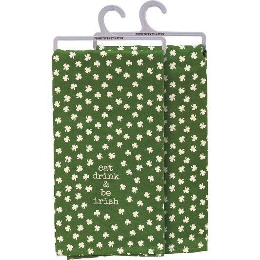 Green towel with white shamrock pattern and 'eat drink & be Irish' text on a hanger.