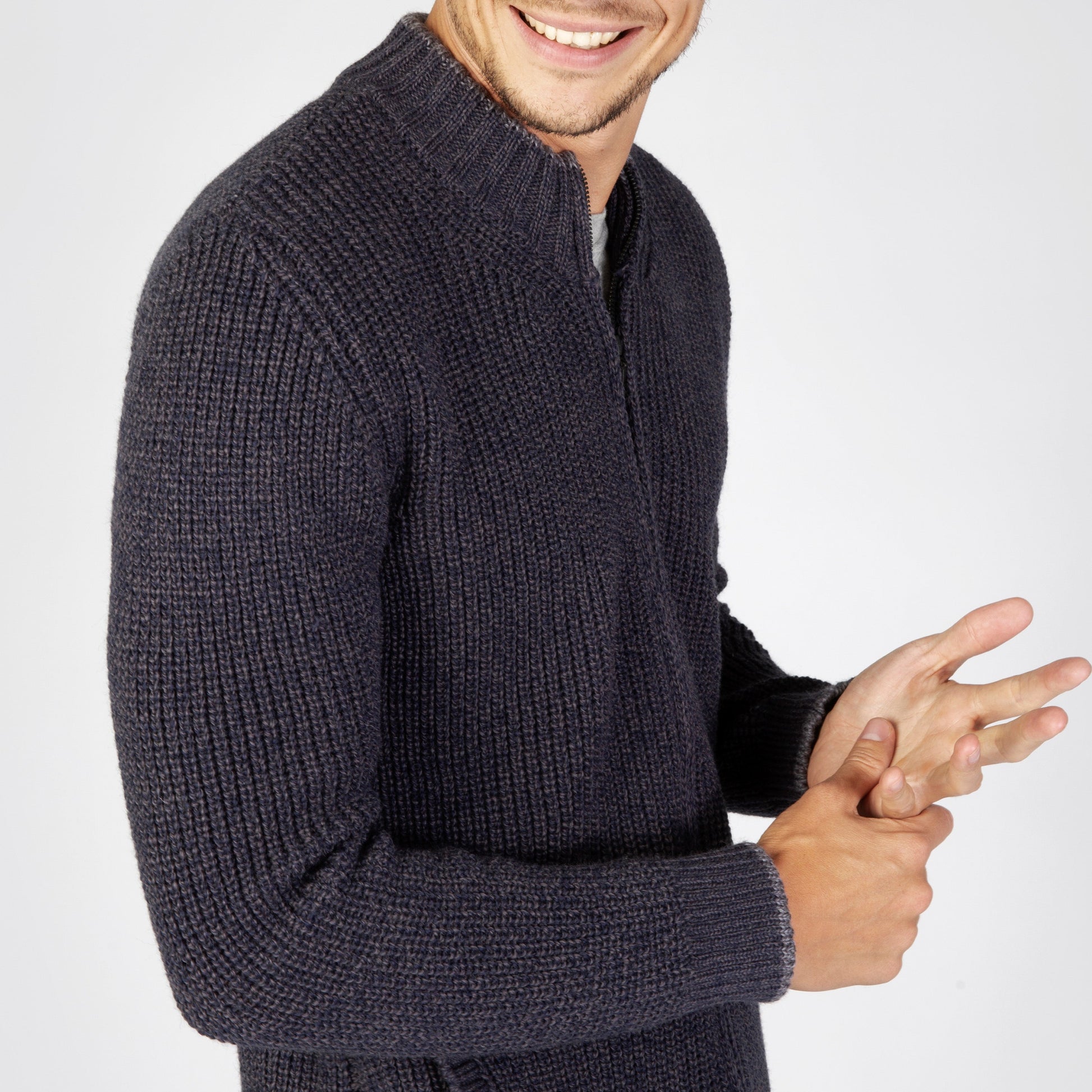 Man wearing a dark gray knitted sweater on a white background