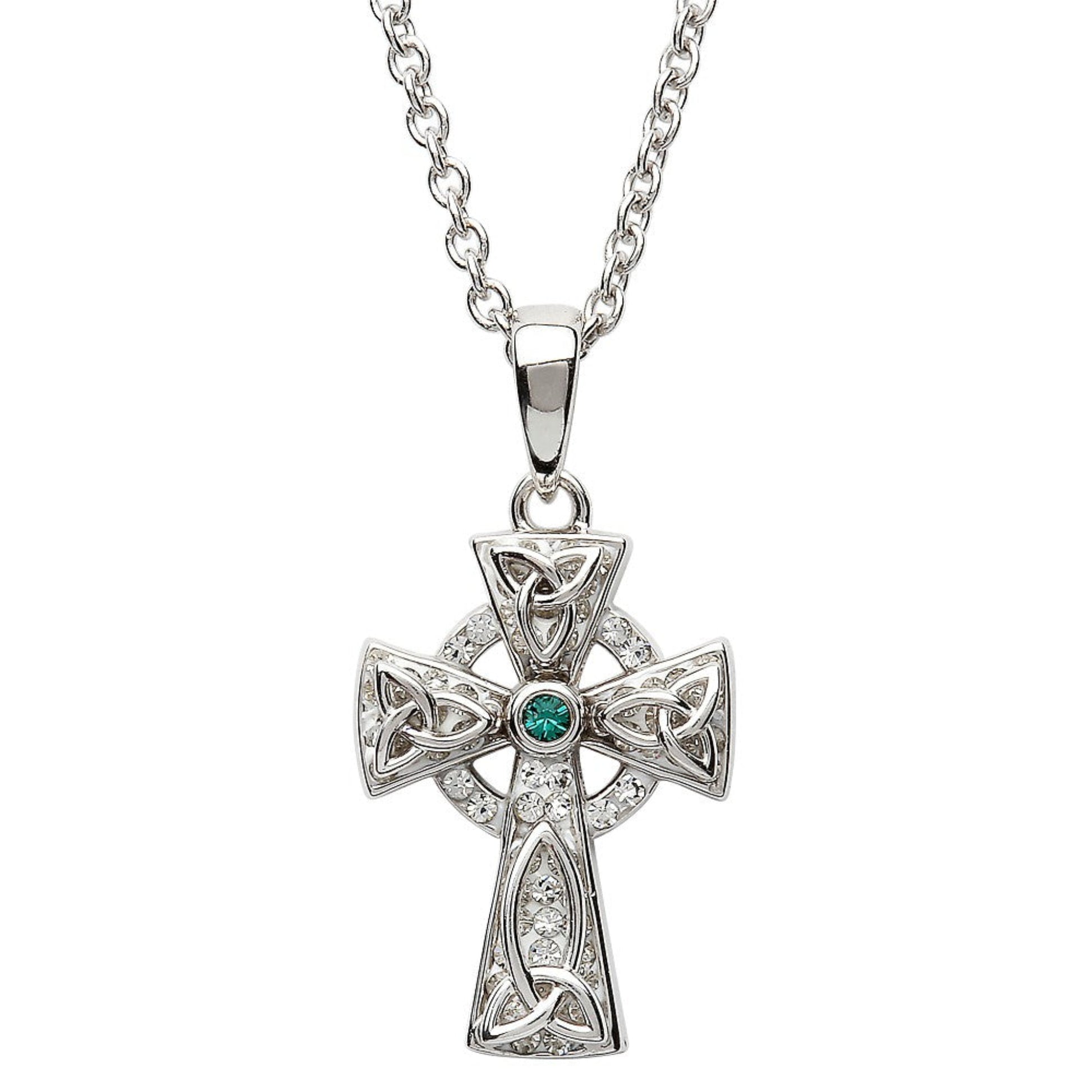 A sterling silver Celtic cross necklace with a green stone in the center, surrounded by smaller clear crystals.