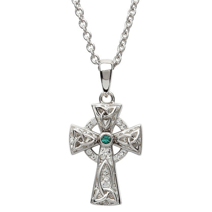 A sterling silver Celtic cross necklace with a green stone in the center, surrounded by smaller clear crystals.