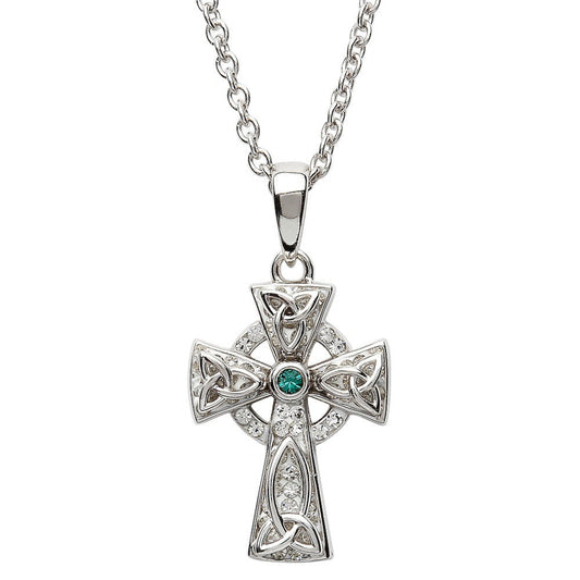 A sterling silver Celtic cross necklace with a green stone in the center, surrounded by smaller clear crystals.