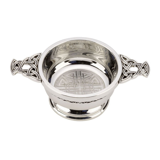 Silver colored bowl with celtic knotwork handles and a celtic knot in the bottom of the center