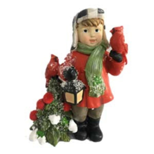 Decorative figurine of a child dressed warmly holding a lantern in one hand and a cardinal in the other.