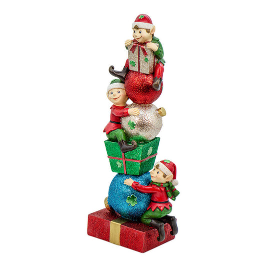 Decorative figurine of three Irish elves stacking presents and ornaments