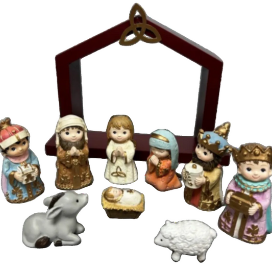 A nativity set including six human figures, one baby jesus, a donkey, a lam, and a manger frame.