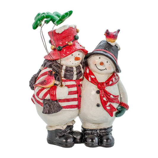 Two snowmen standing close together dressed in warm clothing. One holds shamrock "balloons" and one has a cardinal on her head.