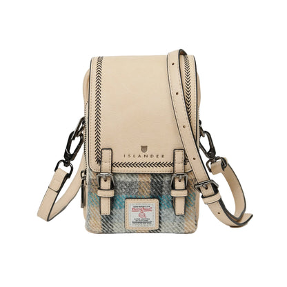 A green Baby Jura Crossbody bag made with Harris Tweed and vegan leather, featuring multiple pockets and a detachable strap.