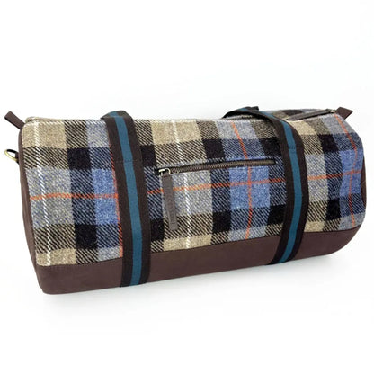 Plaid duffel bag with brown accents on a white background