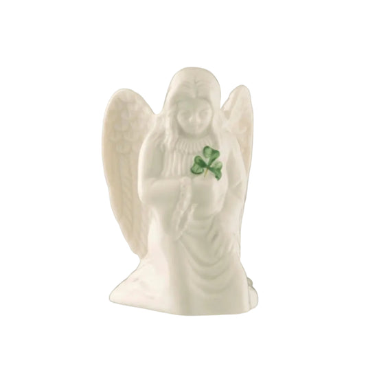 A white porcelain figurine of an angel holding a green leaf.