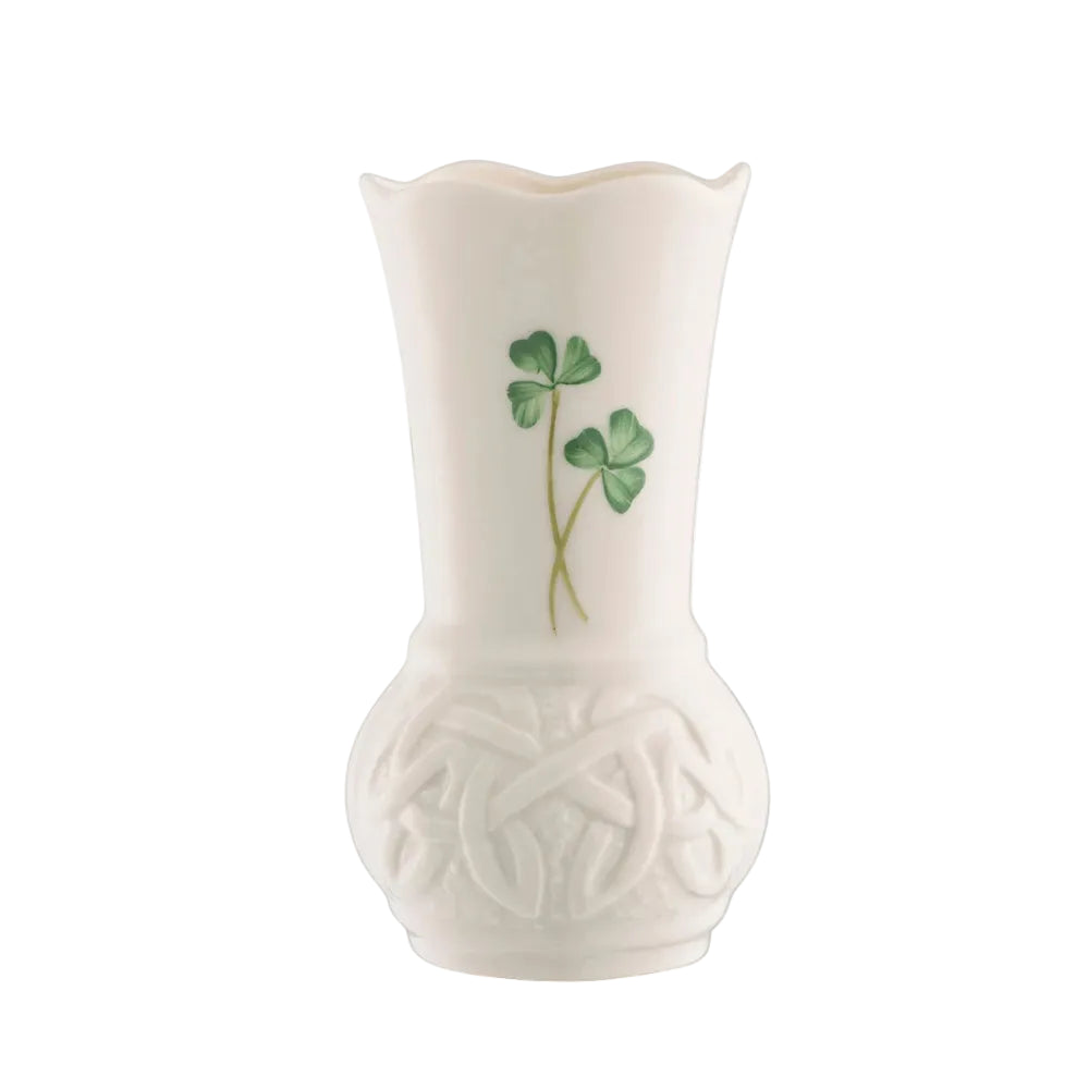 A white ceramic vase with a floral pattern, featuring a shamrock design on the side.