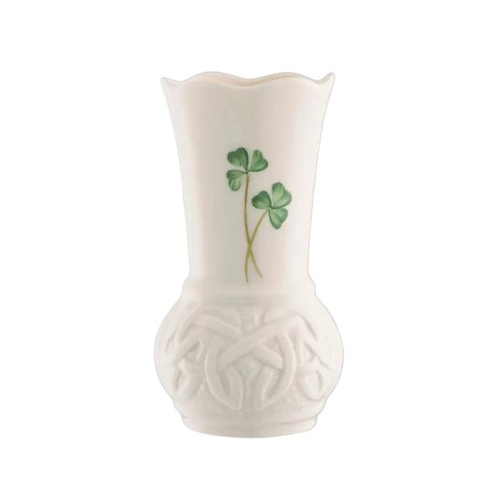 A white ceramic vase with a floral pattern, featuring a shamrock design on the side.