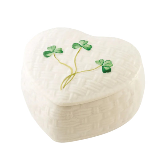 A white wicker-like trinket box with green hand-painted shamrocks and a floral design on the lid.