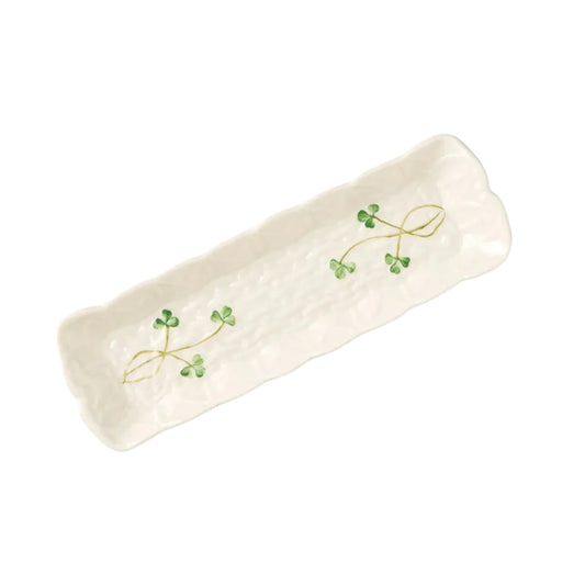 A white decorative tray with a pattern of clover leaves.