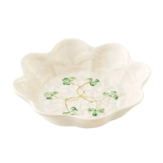 A white ceramic decorative bowl with a shamrock pattern in the center.