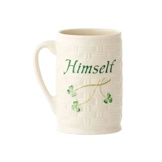 A white ceramic mug with green text reading 'Himself' and decorated with green shamrocks.