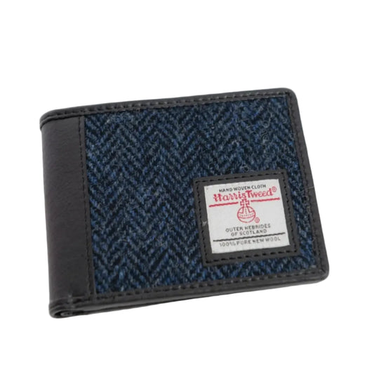 A bifold wallet with a combination of dark blue herringbone pattern and leather, featuring the Harris Tweed label.