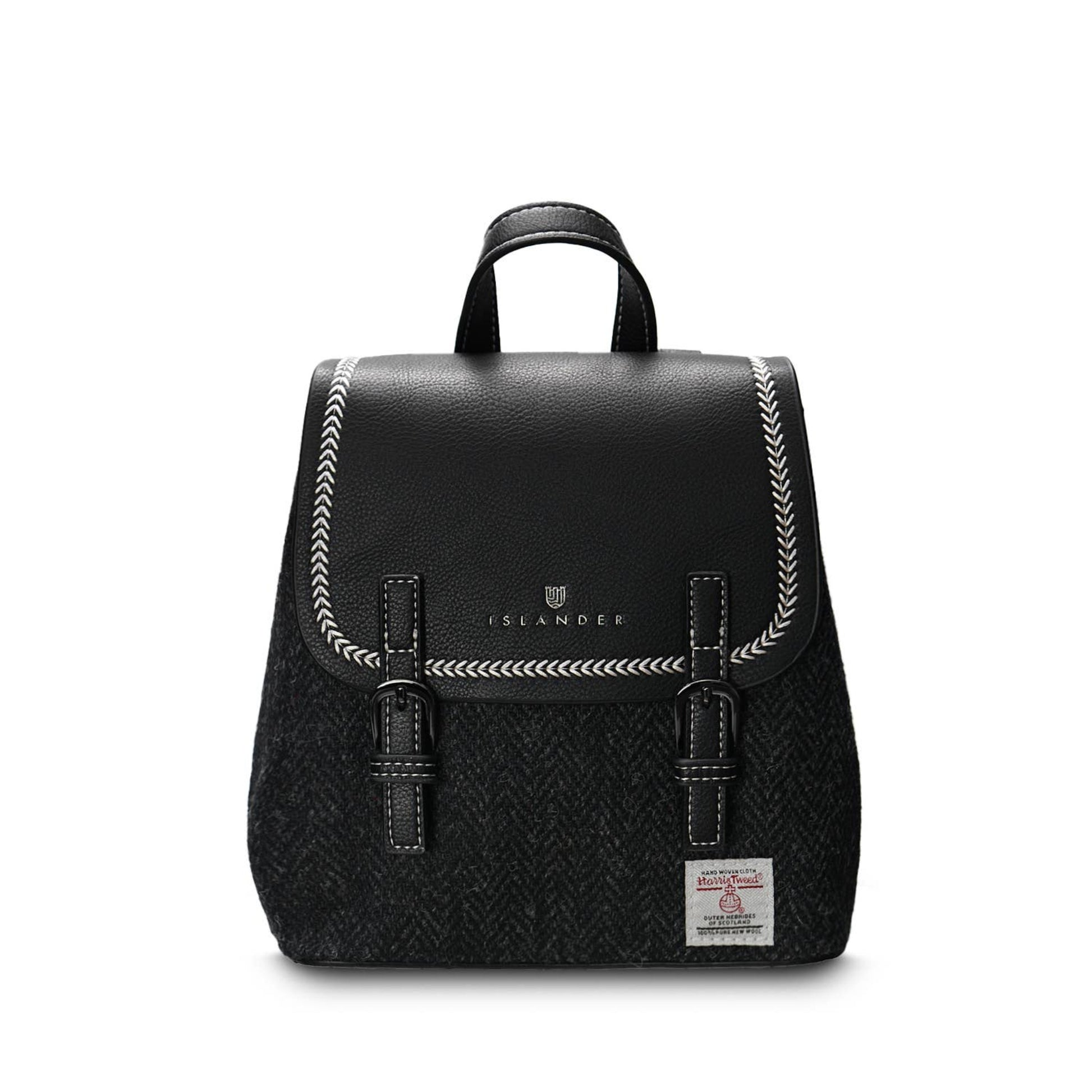 A black Mini Jura backpack with a PU leather body and a Harris Tweed front panel, featuring a magnetic clasp, hidden zip pocket, reinforced handle, and adjustable shoulder straps.