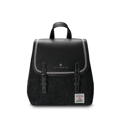 A black Mini Jura backpack with a PU leather body and a Harris Tweed front panel, featuring a magnetic clasp, hidden zip pocket, reinforced handle, and adjustable shoulder straps.