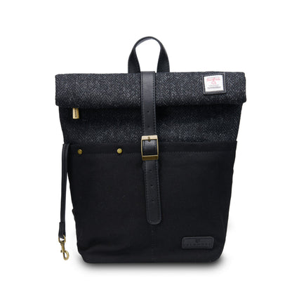 Black backpack with a textured top section on a white background