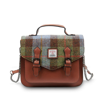 Plaid bag with brown leather accents on a white background