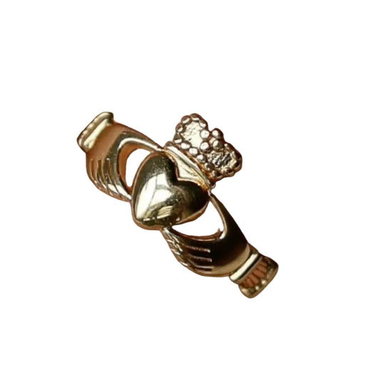 Close-up of a golden claddagh ring on a white background