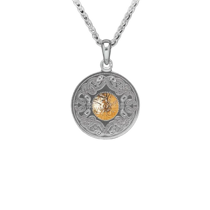 A necklace with a silver pendant. The pendant is intricately carved with twisting Celtic serpents. There is a gold bead in the center.