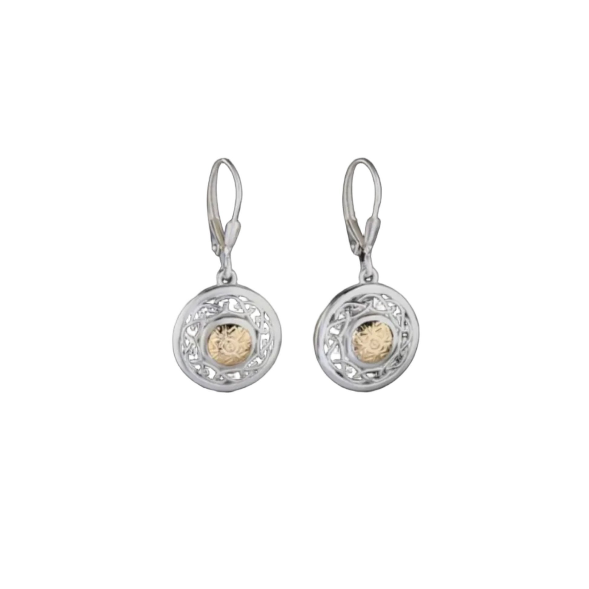 A pair of intricately carved, shield-shaped silver drop earrings with gold beads in the center.
