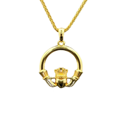 A golden necklace with a golden, round claddagh pendant. 
