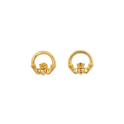 A pair of round, golden claddagh earrings.