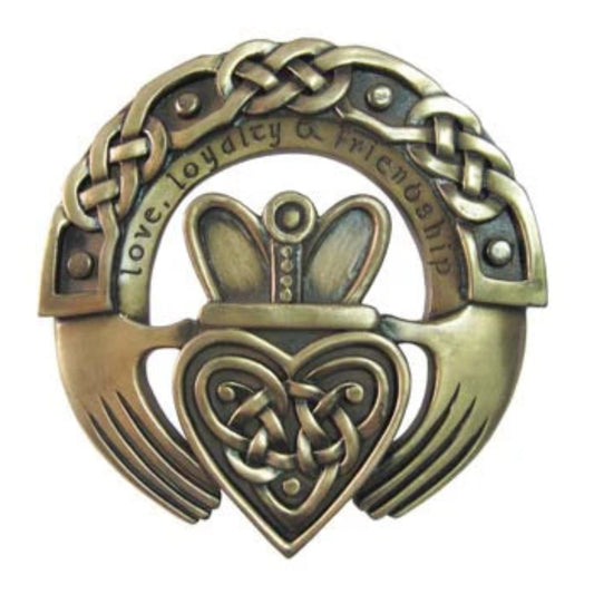 Bronze Claddagh ring with heart design on a white background
