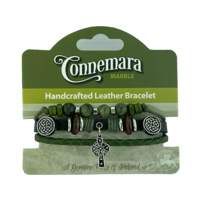 Handcrafted leather bracelet with beads and Celtic knot charm on Connemara Marble packaging.