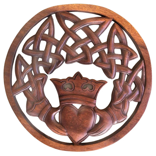 Wooden plaque with Celtic knot design and heart emblem on a textured surface