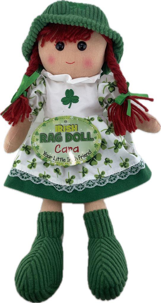 Irish rag doll with green hat, red hair, and white apron with shamrock design on a white background