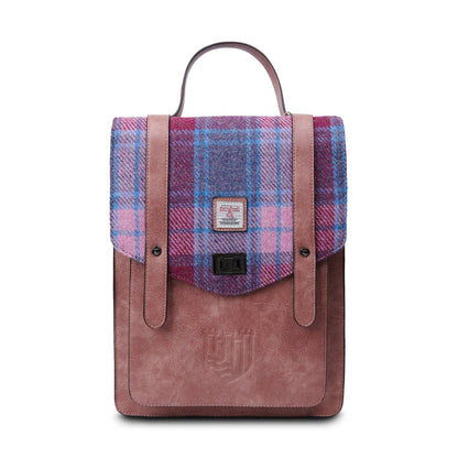 A brown and purple plaid backpack with a microfiber leather body and a Harris Tweed lid, featuring a dual-buckle closure and an adjustable shoulder strap.